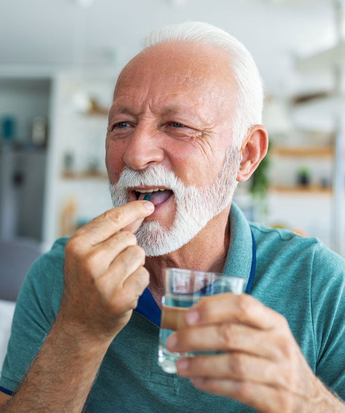 Patient taking prescription with water