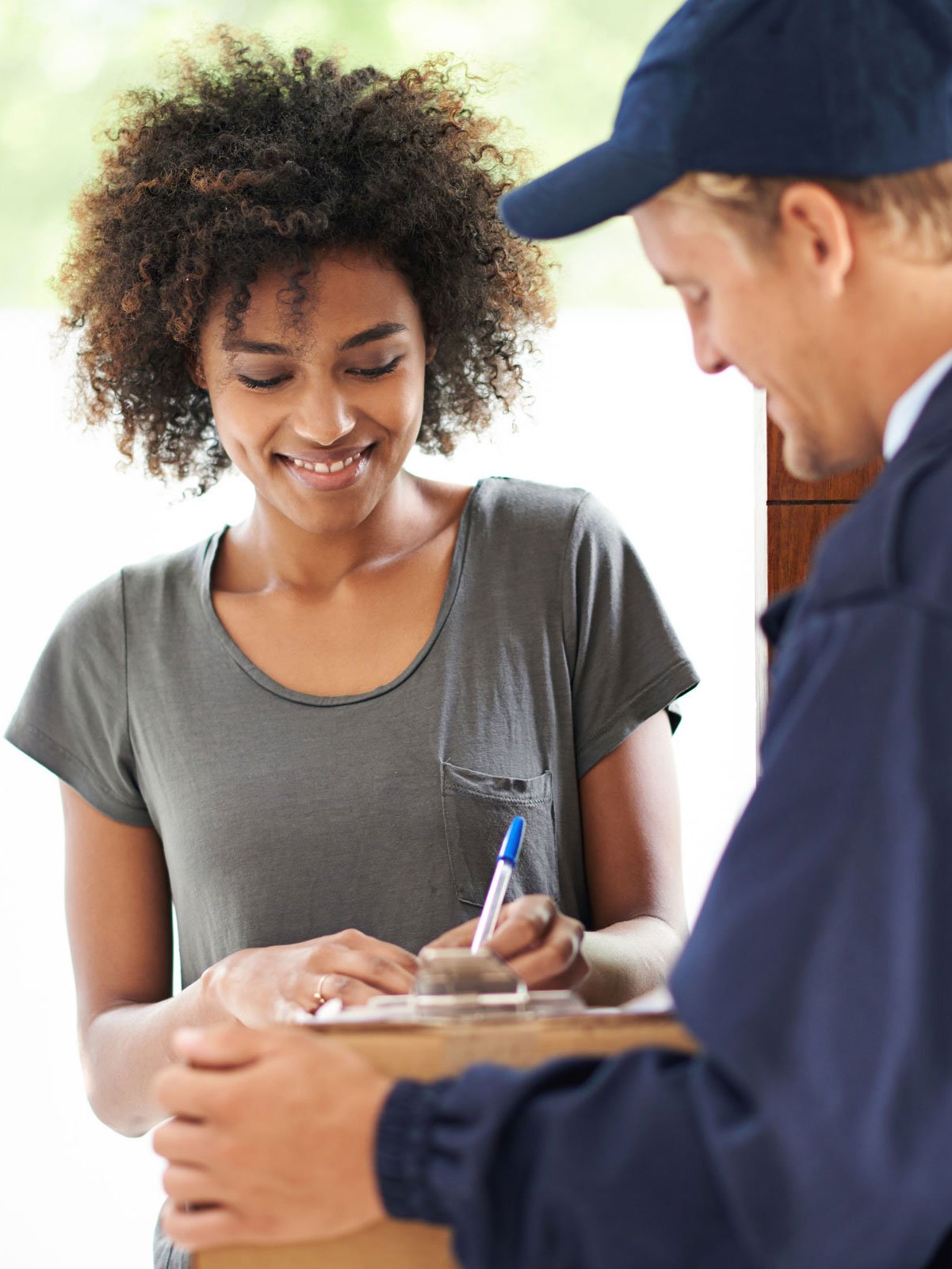 Woman signing for parcel