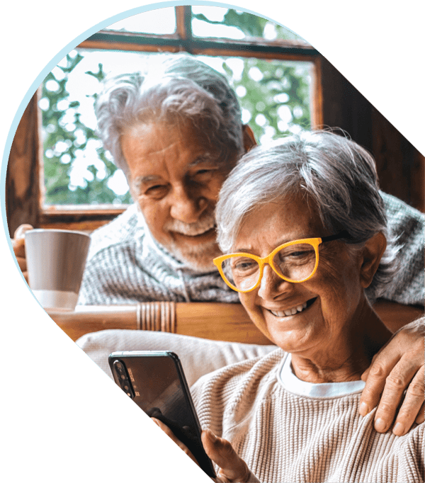 Elderly couple looking at cell phone